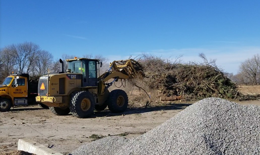 Trucks begin hauling away downed branches from last week s storm