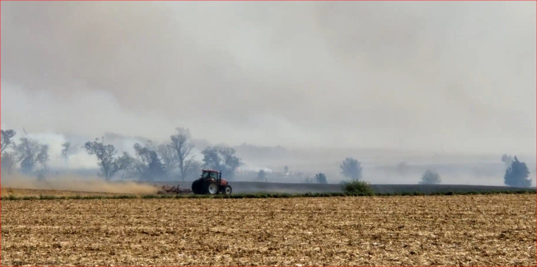 Farmer helping to cut fire line