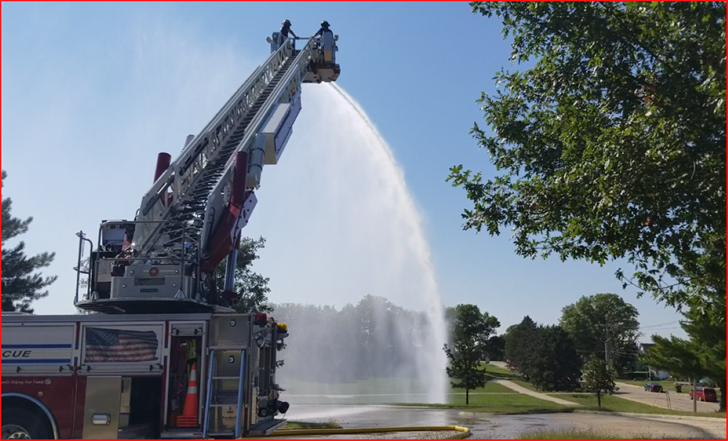 Firefighters atop aerial ladder